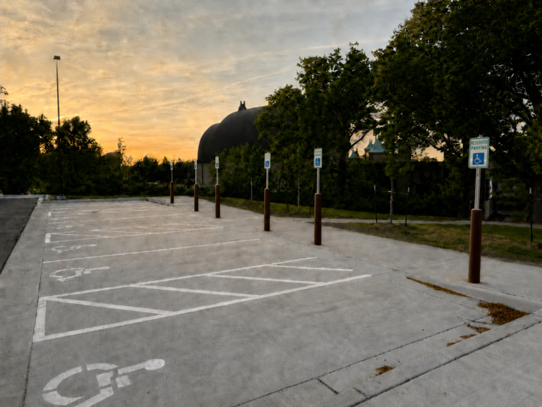 ADA parking stalls with bollards and pavement markings at the Kansas City Zoo.